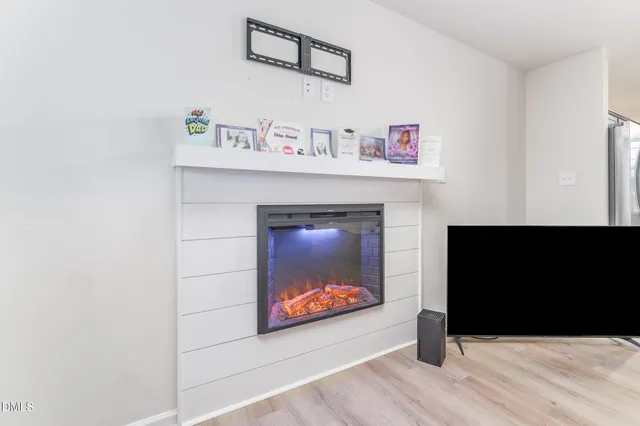 a living room with a fireplace and a flat screen tv