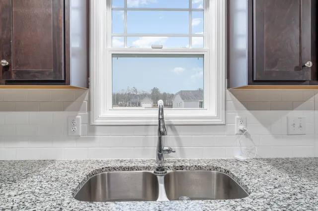 a kitchen with a sink and a window