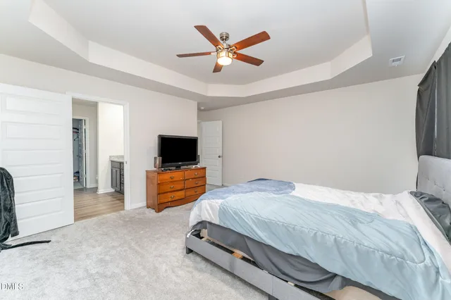 a bedroom with a large bed and a flat screen tv