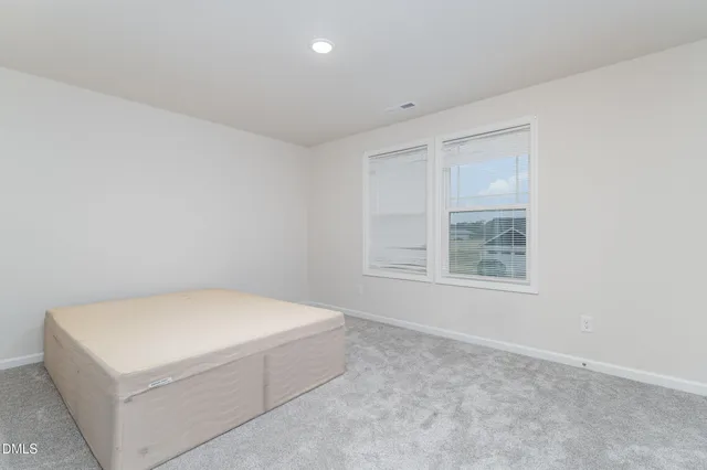 a room with a bed and a window