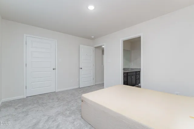 a large white bed in a white room