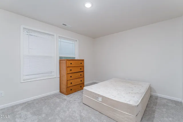 an empty room with a dresser