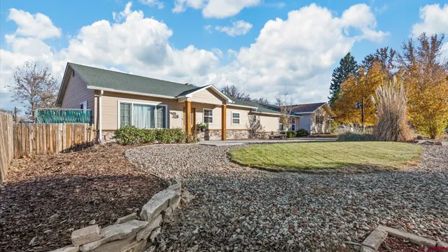 a view of a house with a backyard