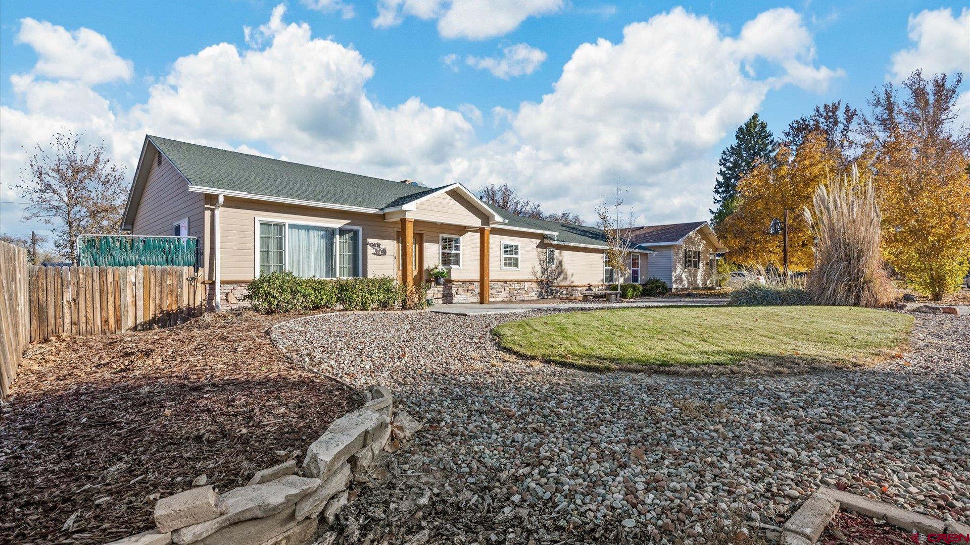 a view of a house with a backyard