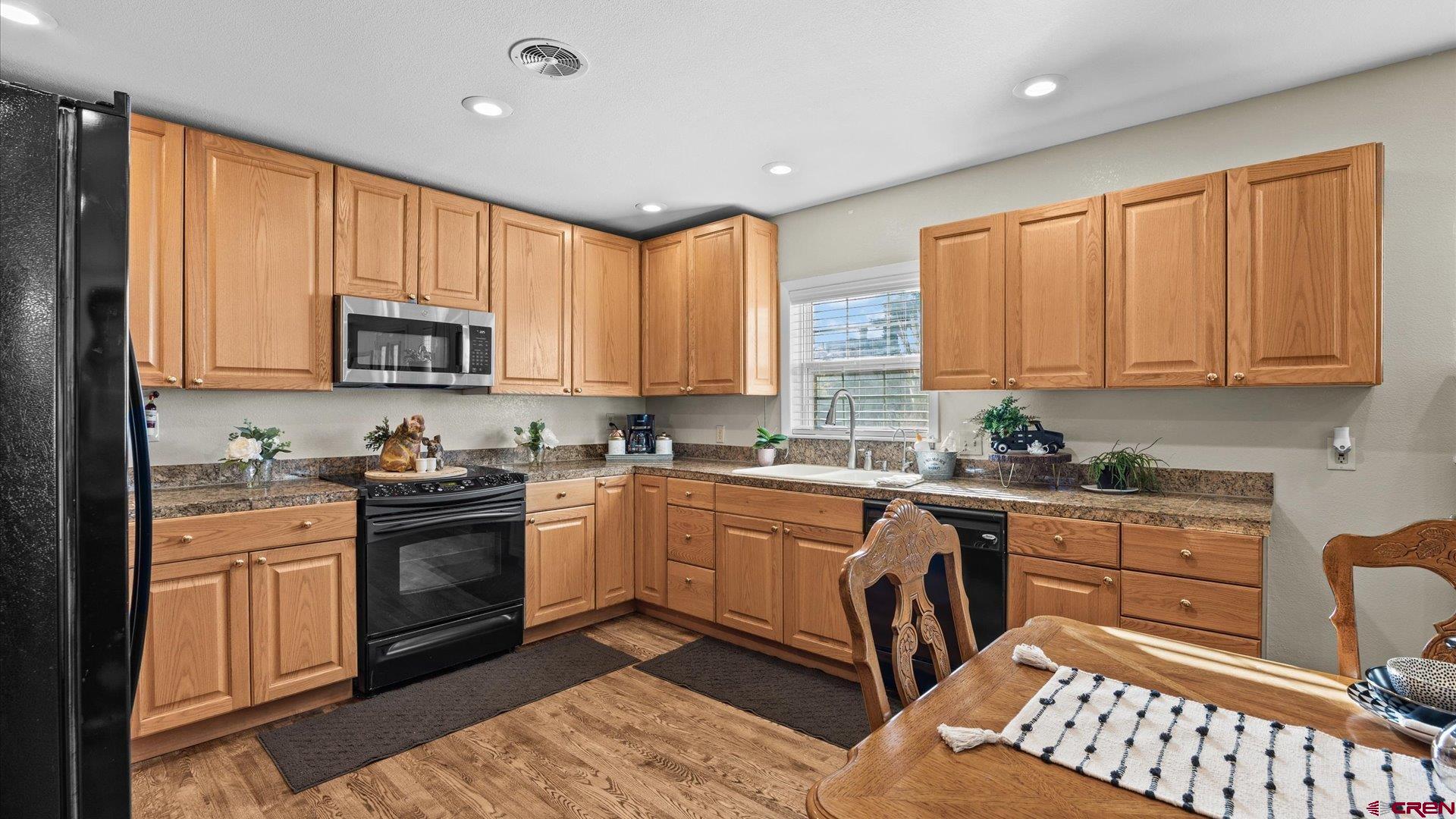 522 Leon Street Delta, CO 81416 - Photo 19 of 31 a kitchen with stainless steel appliances granite countertop a stove top oven a sink dishwasher and cabinets with wooden floor