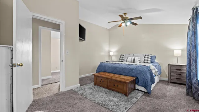 a bathroom with a granite countertop toilet sink and mirror