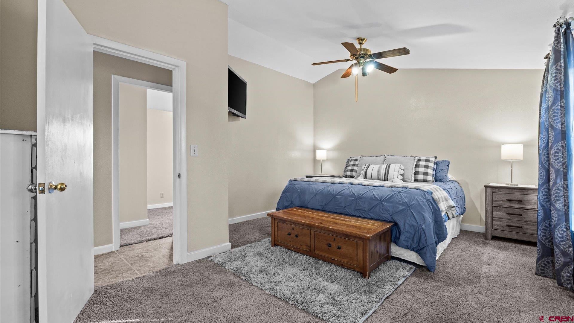 522 Leon Street Delta, CO 81416 - Photo 20 of 31 a bedroom with a bed and a ceiling fan