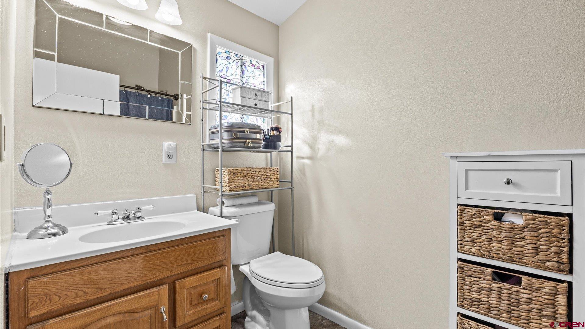522 Leon Street Delta, CO 81416 - Photo 22 of 31 a bathroom with a granite countertop toilet sink and mirror