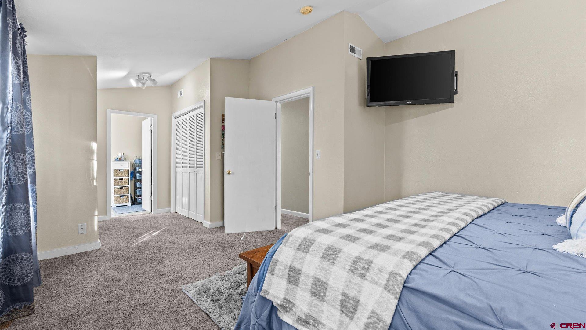 522 Leon Street Delta, CO 81416 - Photo 8 of 33 a bedroom with a bed and a flat screen tv