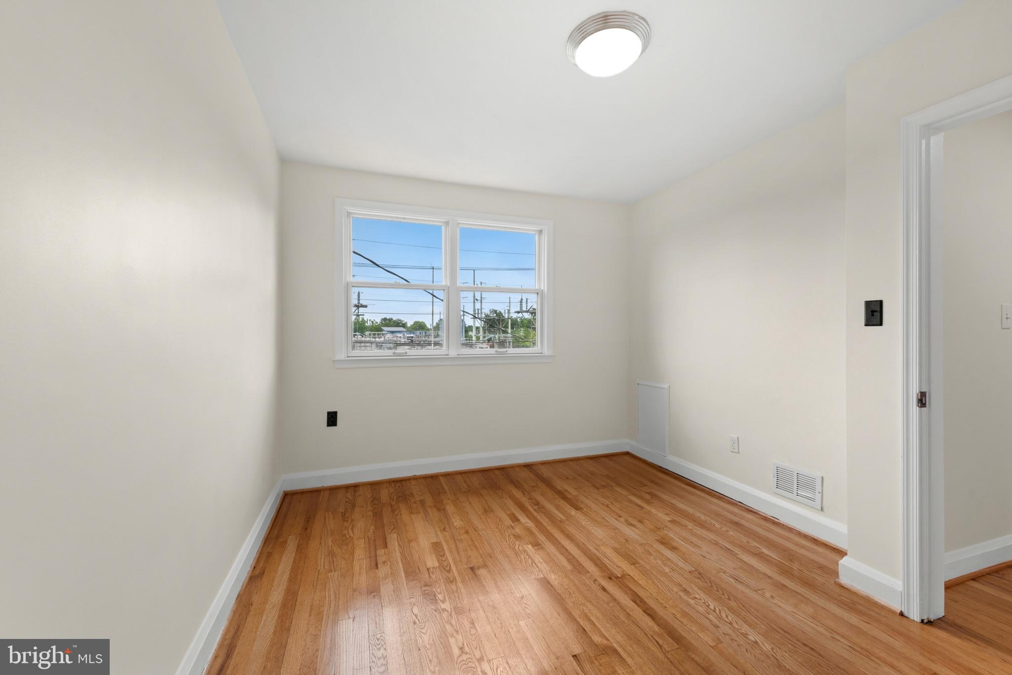 2207 Hawthorne Road Baltimore, MD 21220 - Photo 28 of 39 an empty room with wooden floor and windows