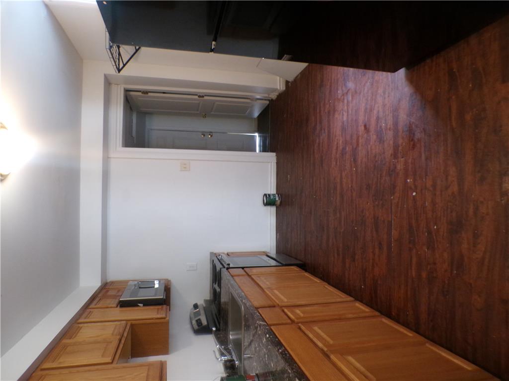 111 Ridge Avenue Allentown, PA 18102 - Photo 6 of 15 A compact kitchen offering wooden cabinetry and durable flooring for daily culinary tasks. View from dining room