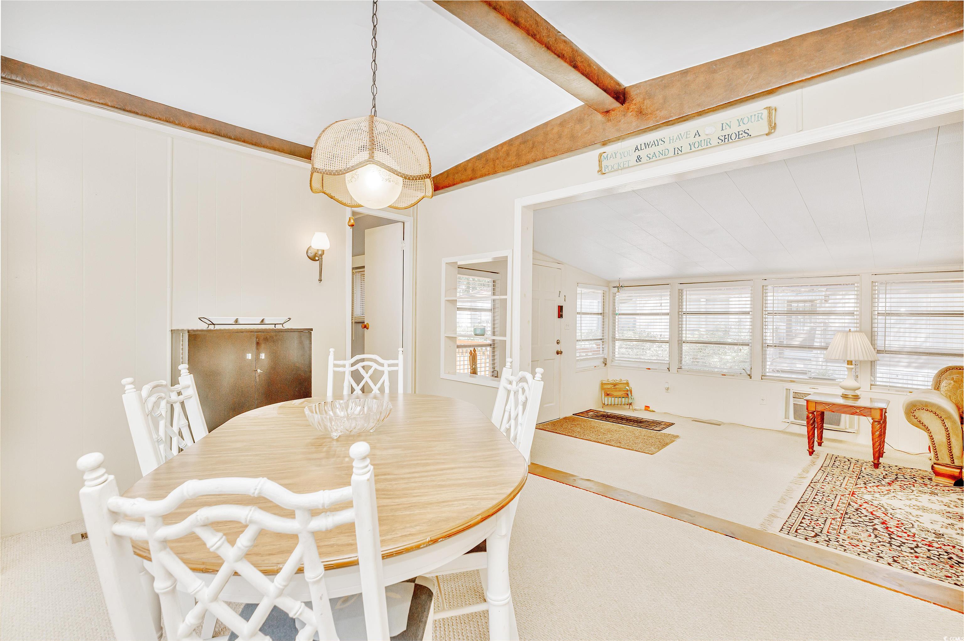 413 Delton Drive Murrells Inlet, SC 29576 - Photo 14 of 34 Dining space with lofted ceiling with beams and carpet flooring