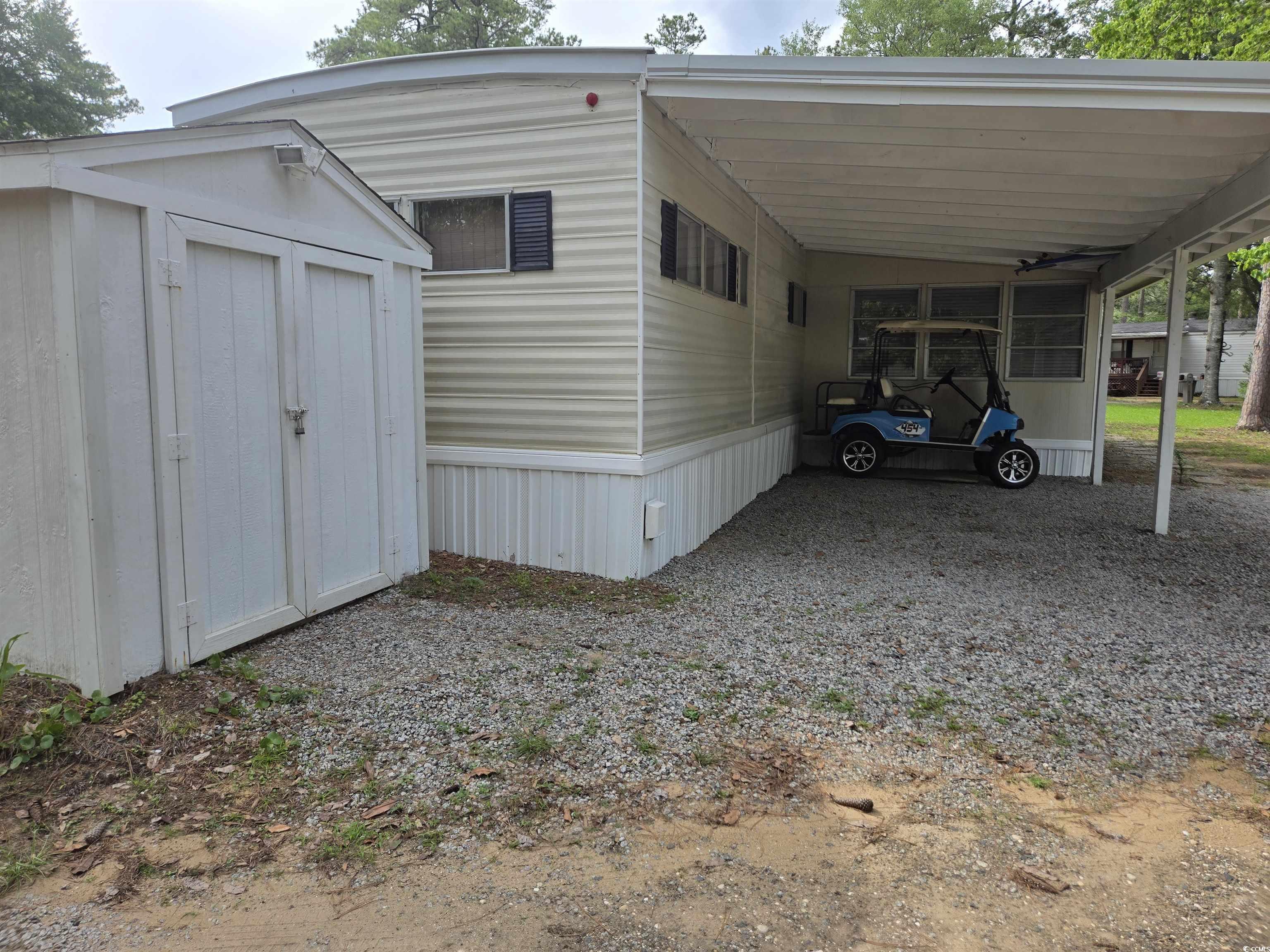 413 Delton Drive Murrells Inlet, SC 29576 - Photo 3 of 34 View of side of property with a carport and driveway