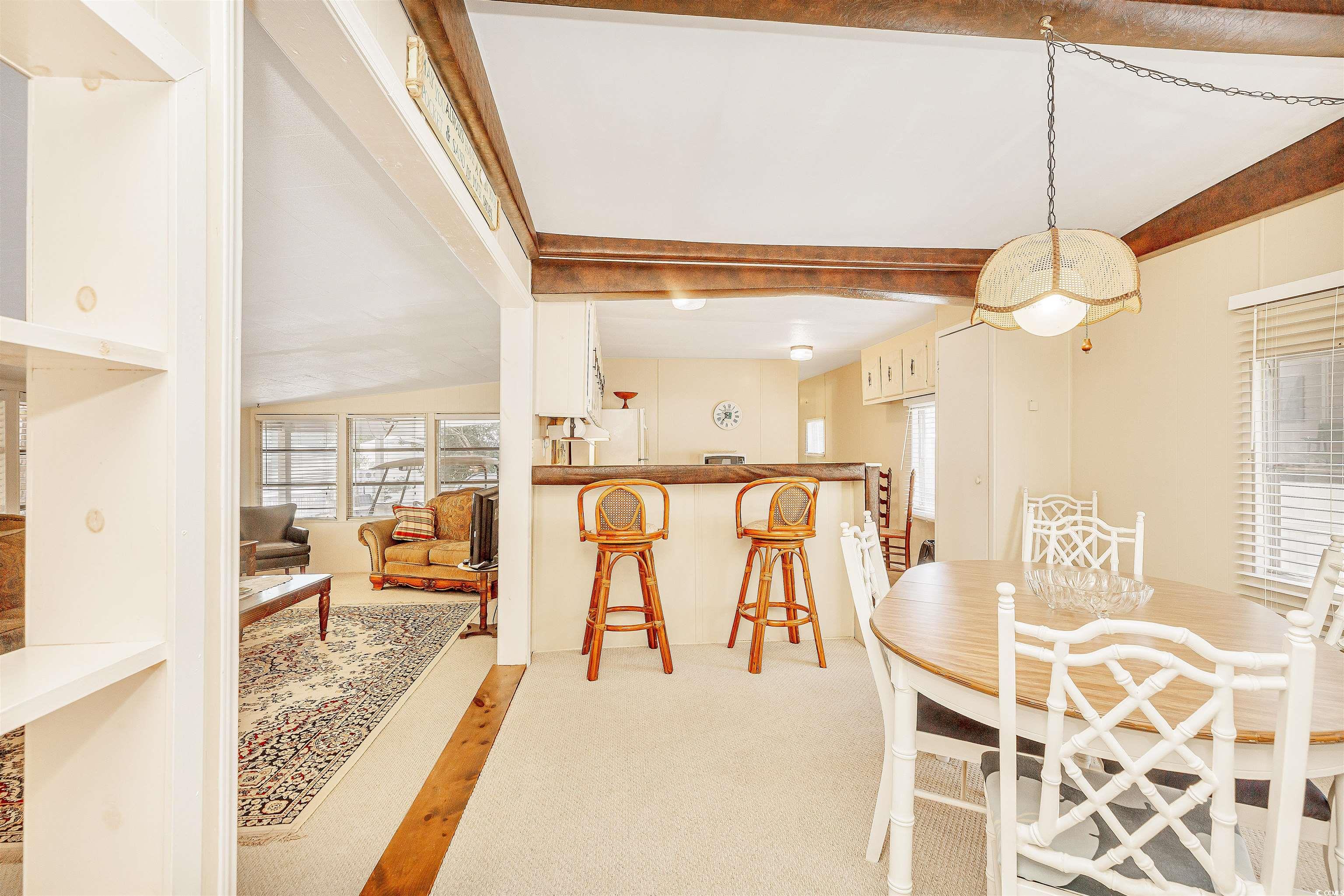 413 Delton Drive Murrells Inlet, SC 29576 - Photo 10 of 34 Dining area featuring a healthy amount of sunlight and beam ceiling