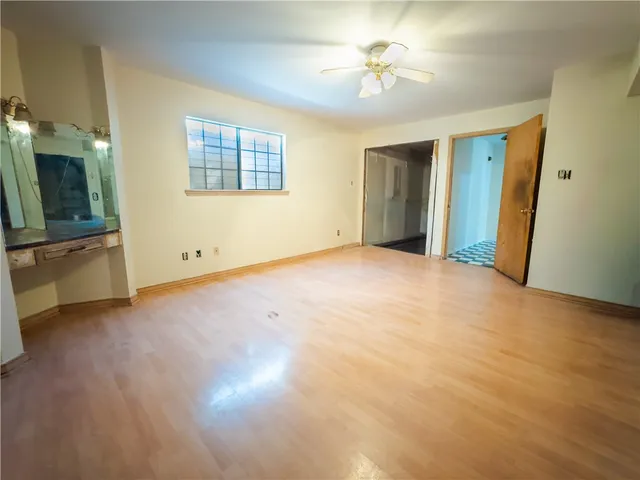 an empty room with windows and closet