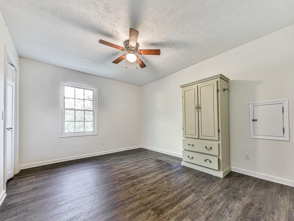 87 Jones Street Jasper, GA 30143 - Photo 11 of 25 wooden floor in an empty room with a window
