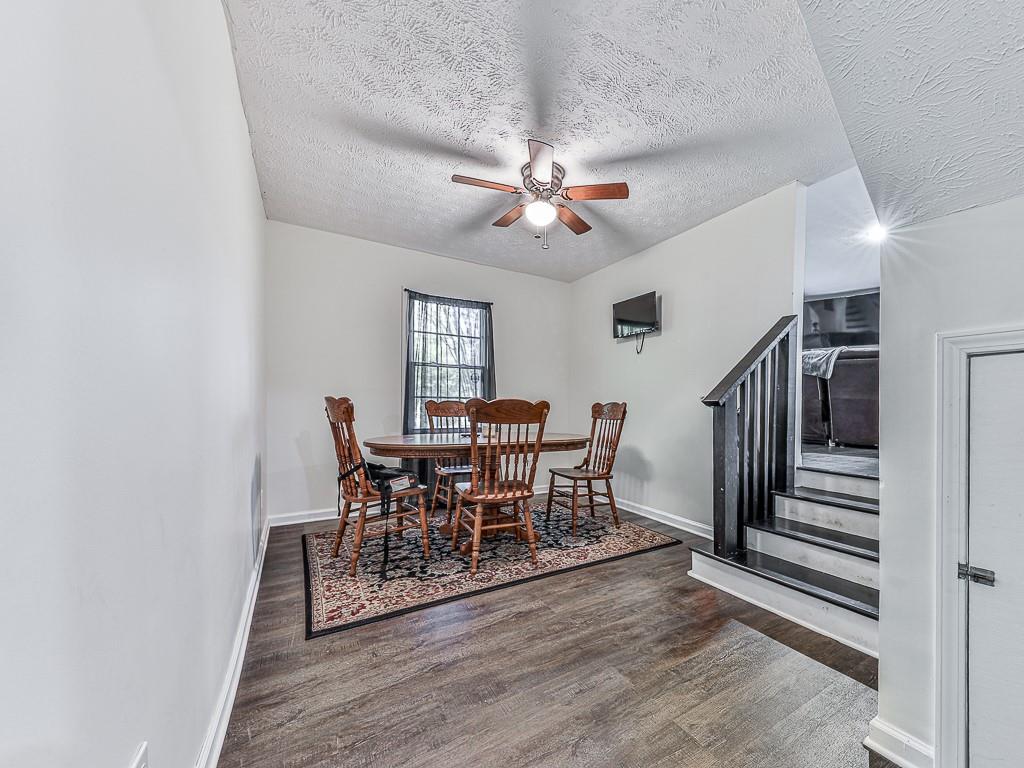 87 Jones Street Jasper, GA 30143 - Photo 16 of 25 a dining room with furniture entryway and wooden floor