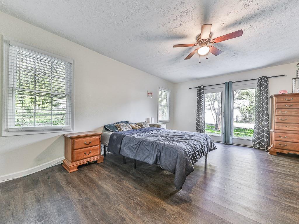 87 Jones Street Jasper, GA 30143 - Photo 18 of 25 a spacious bedroom with a bed and a chandelier