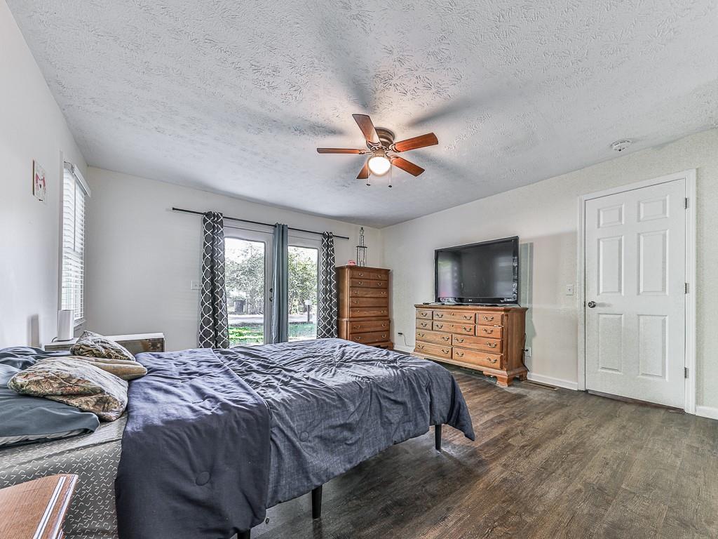 87 Jones Street Jasper, GA 30143 - Photo 19 of 25 a bedroom with a large bed and a flat screen tv