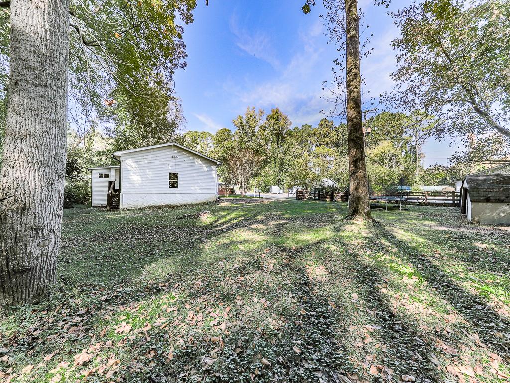 87 Jones Street Jasper, GA 30143 - Photo 22 of 25 a view of a house with backyard and trees
