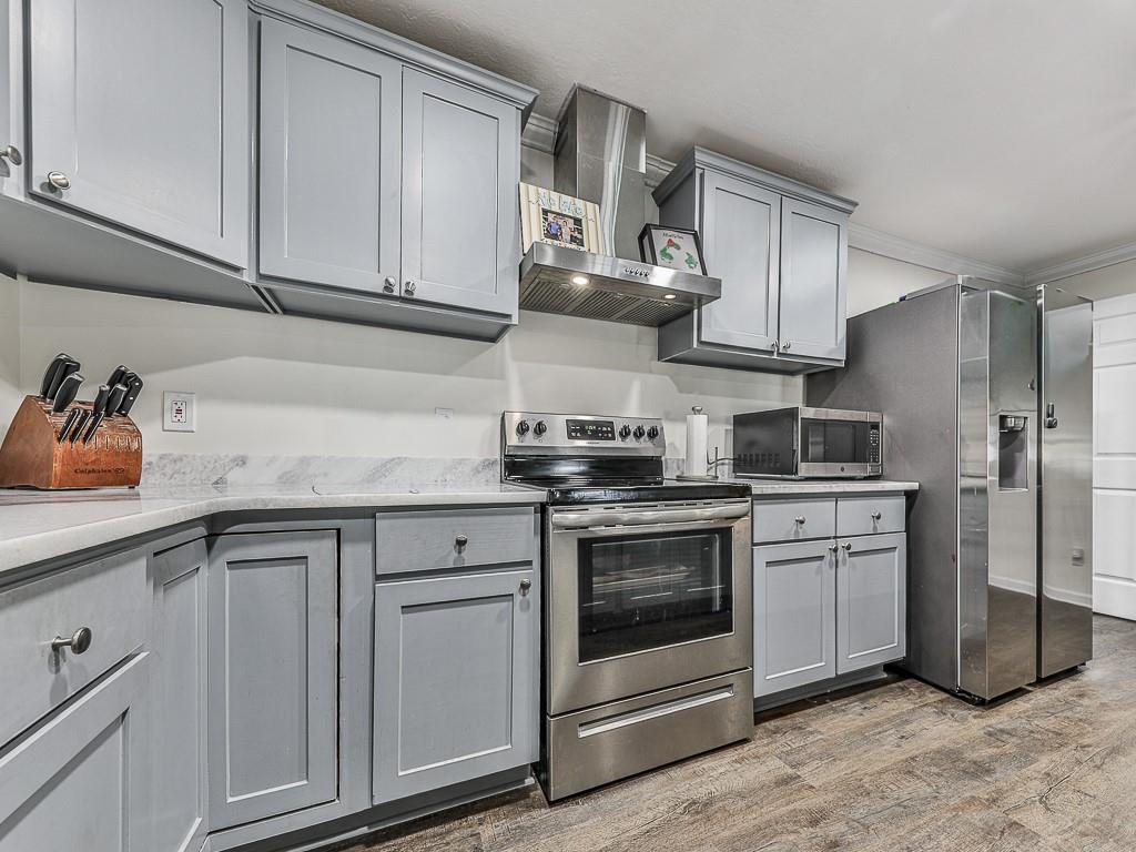 87 Jones Street Jasper, GA 30143 - Photo 3 of 25 a kitchen with stainless steel appliances granite countertop a sink a stove and cabinets