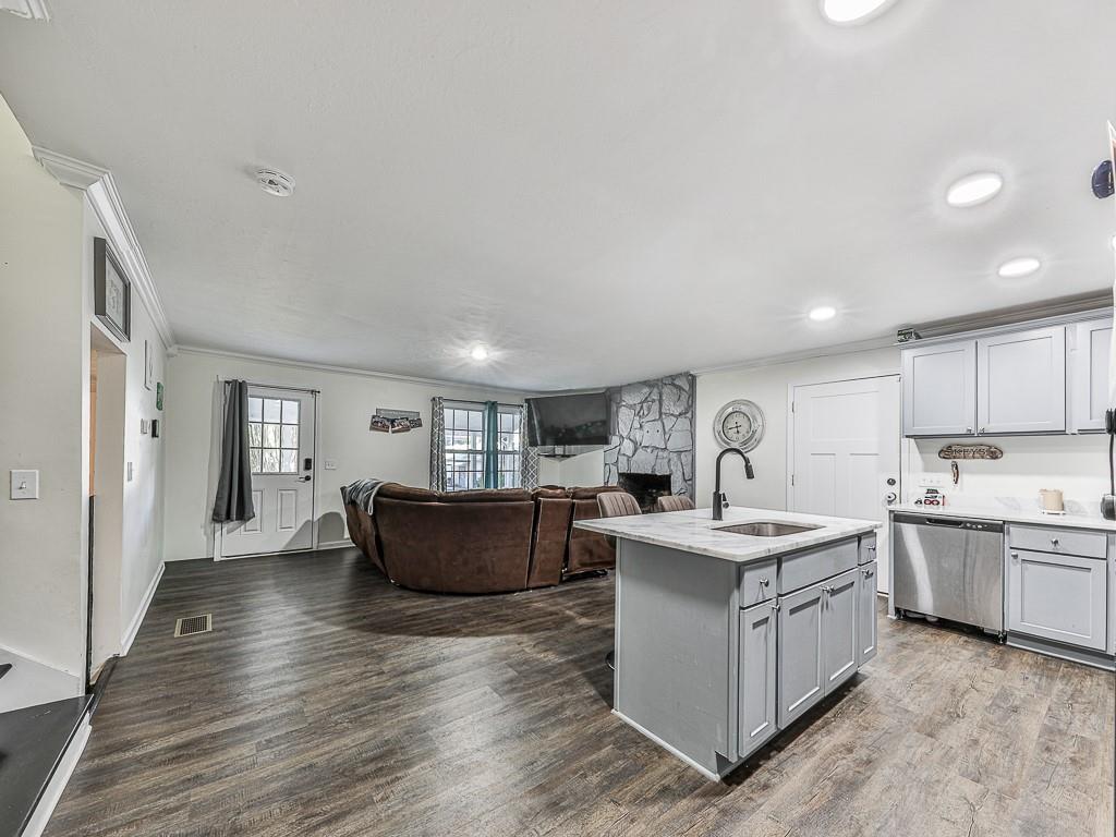 87 Jones Street Jasper, GA 30143 - Photo 6 of 25 a kitchen with a sink stove and wooden cabinets