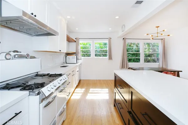 a kitchen with a stove a sink and a refrigerator