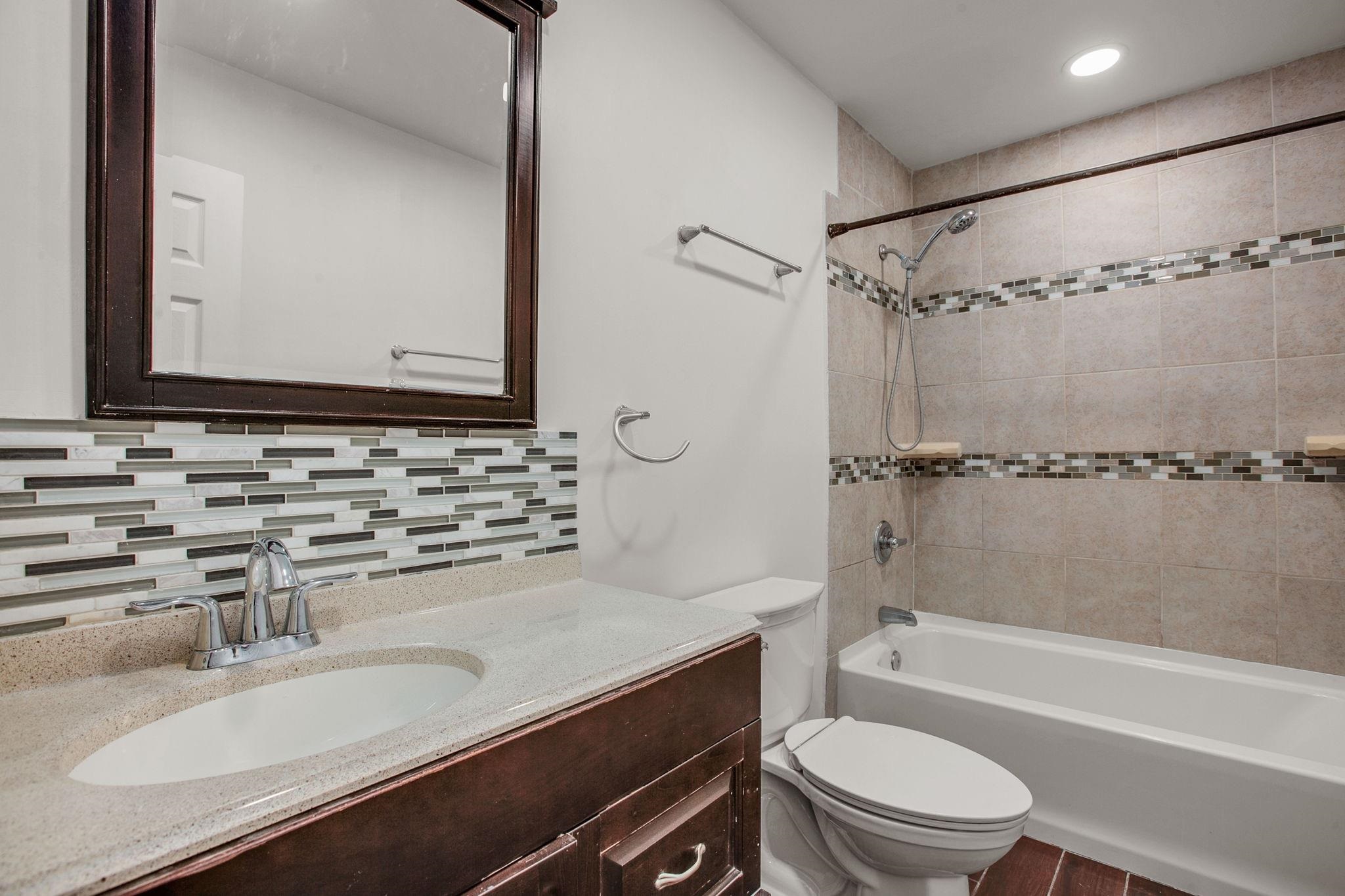 209 Casper Lane Vista, CA 92084 - Photo 6 of 12 a bathroom with a granite countertop sink toilet mirror and shower