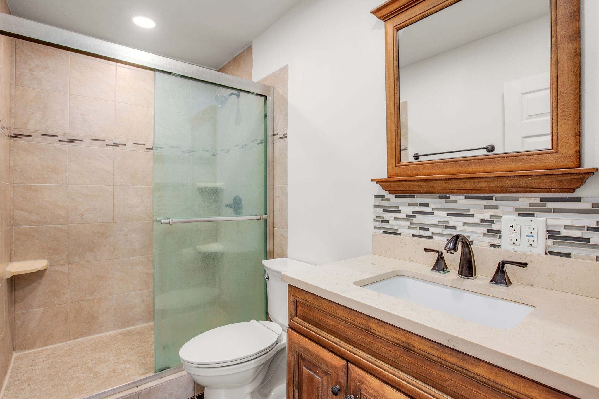 209 Casper Lane Vista, CA 92084 - Photo 7 of 12 a bathroom with a sink a toilet and shower