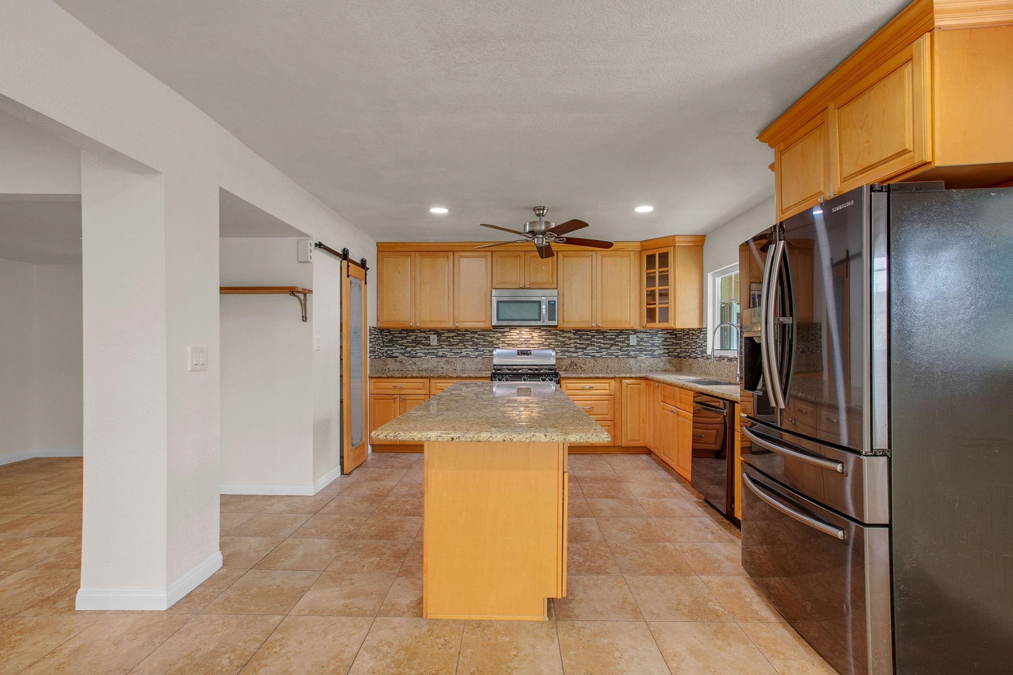 209 Casper Lane Vista, CA 92084 - Photo 9 of 12 a kitchen with stainless steel appliances granite countertop a refrigerator and a sink