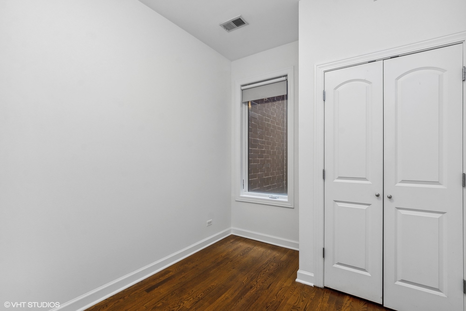 2130 West Rice Street, Unit 3 Chicago, IL 60622 - Photo 14 of 18 a view of an empty room with wooden floor and a window