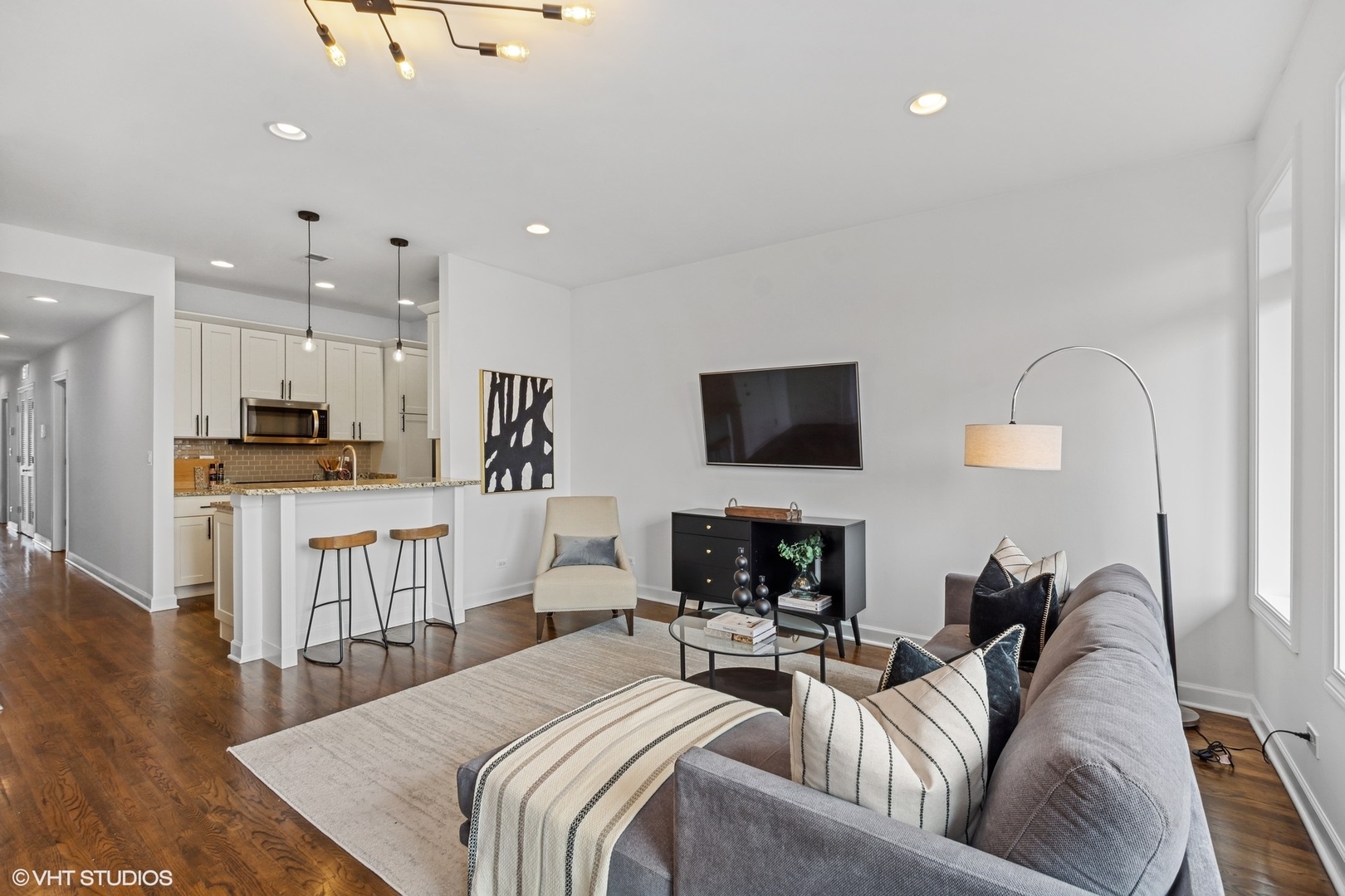 2130 West Rice Street, Unit 3 Chicago, IL 60622 - Photo 5 of 18 a living room with furniture and a flat screen tv
