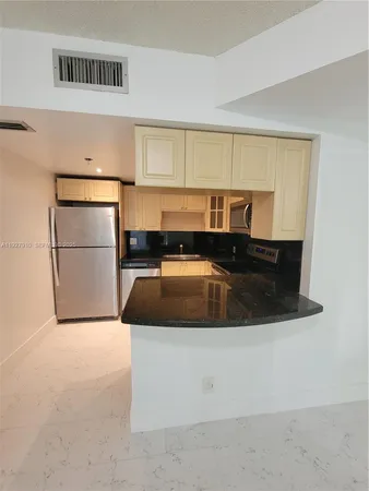 a kitchen with a sink a microwave and cabinets