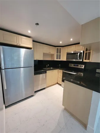 a kitchen with a refrigerator and a stove