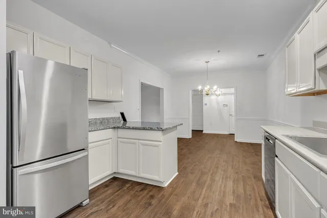 a kitchen with stainless steel appliances a refrigerator sink and microwave