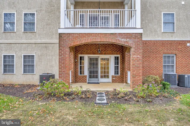 front view of a brick house with a small yard