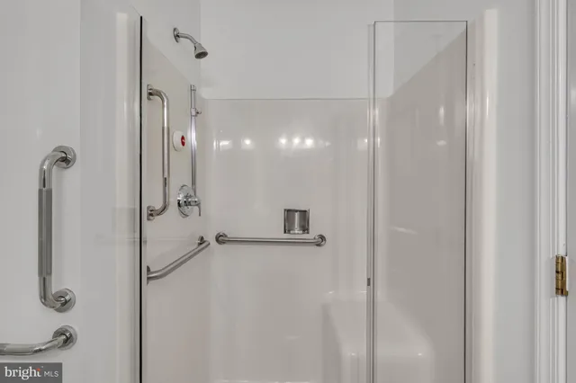 a bathroom with a shower and a glass door