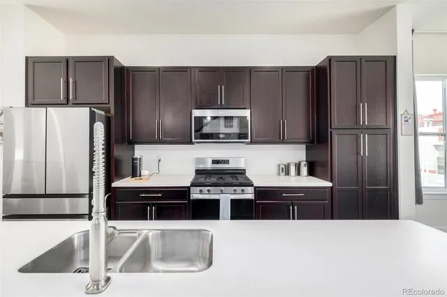 a kitchen with stainless steel appliances a refrigerator and a sink