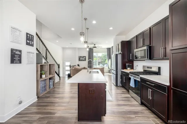 a large kitchen with stainless steel appliances kitchen island granite countertop a large counter top and stove top oven