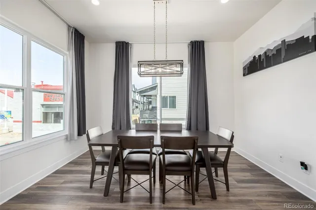 a view of a dining room with furniture windows and wooden floor