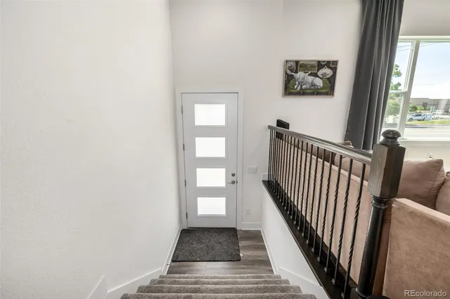 a view of a hallway with wooden floor and a floor to ceiling window