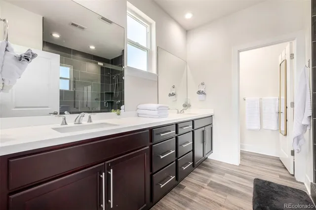 a bathroom with a double vanity sink and a mirror