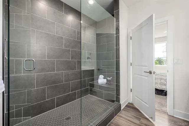 a bathroom with a glass shower door and a sink