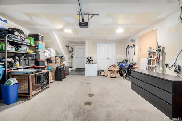 a living room with lots of furniture and clutter
