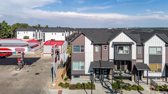 an aerial view of multiple houses with a yard