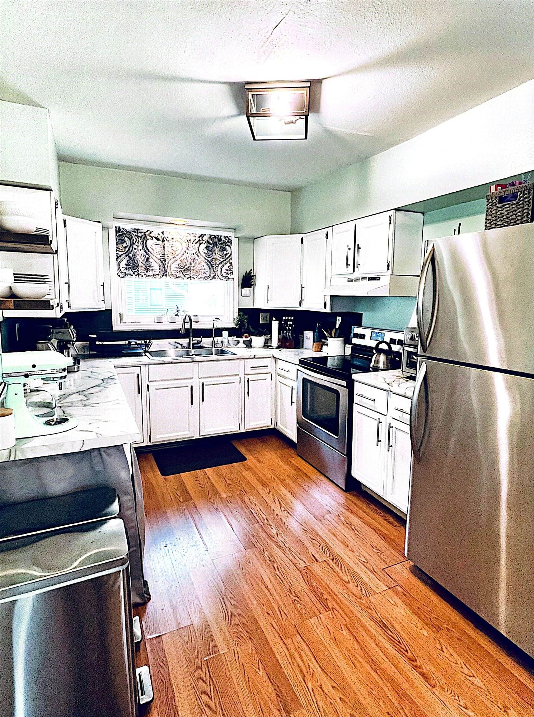 521 North Walnut Street Byron, IL 61010 - Photo 2 of 9 a kitchen with stainless steel appliances granite countertop a sink stove and refrigerator