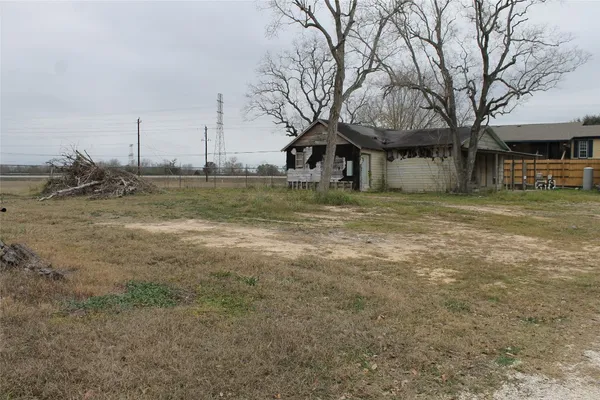 a view of large yard with large trees