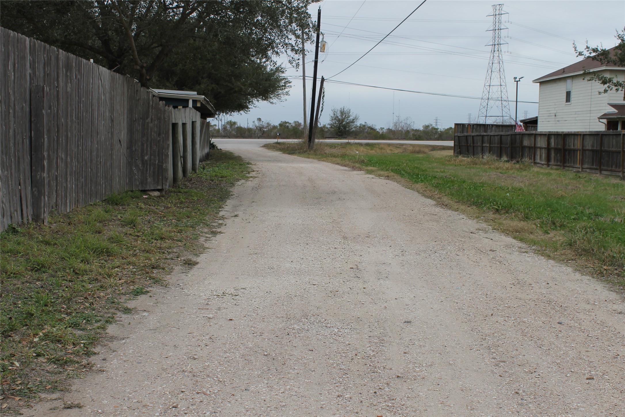 1111 Spur 529 Rosenberg, TX 77471 - Photo 5 of 14 Access road from 1117 Spur 529 which is the rear lot being sold with 1111 Spur 529. This view is looking out to Spur 529.