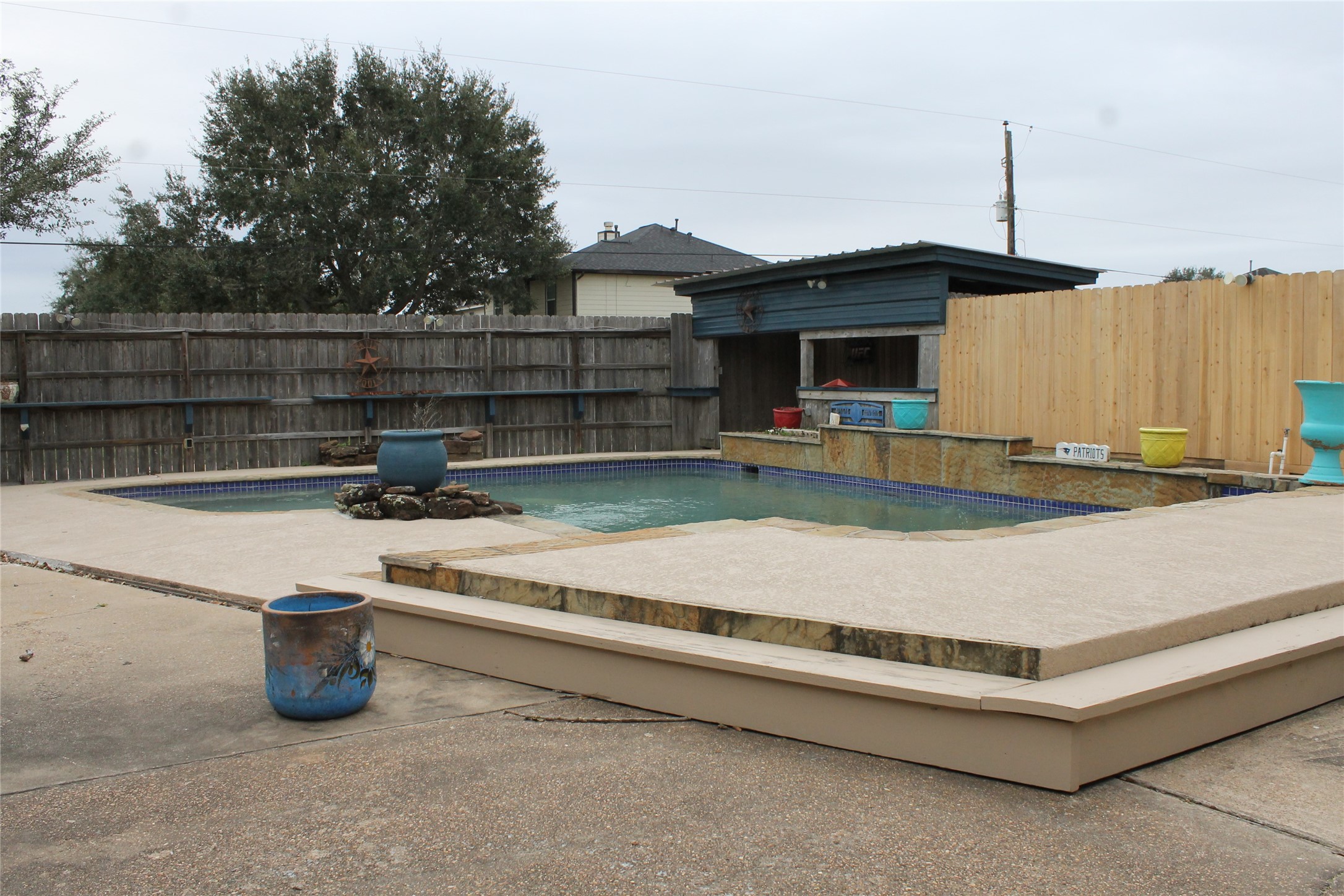 1111 Spur 529 Rosenberg, TX 77471 - Photo 10 of 14 Pool and decking with covered outdoor seating as well. Picture all the fun and memories that can be made in this back yard.