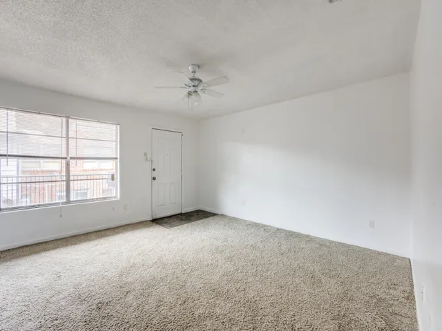 an empty room with a empty space and windows